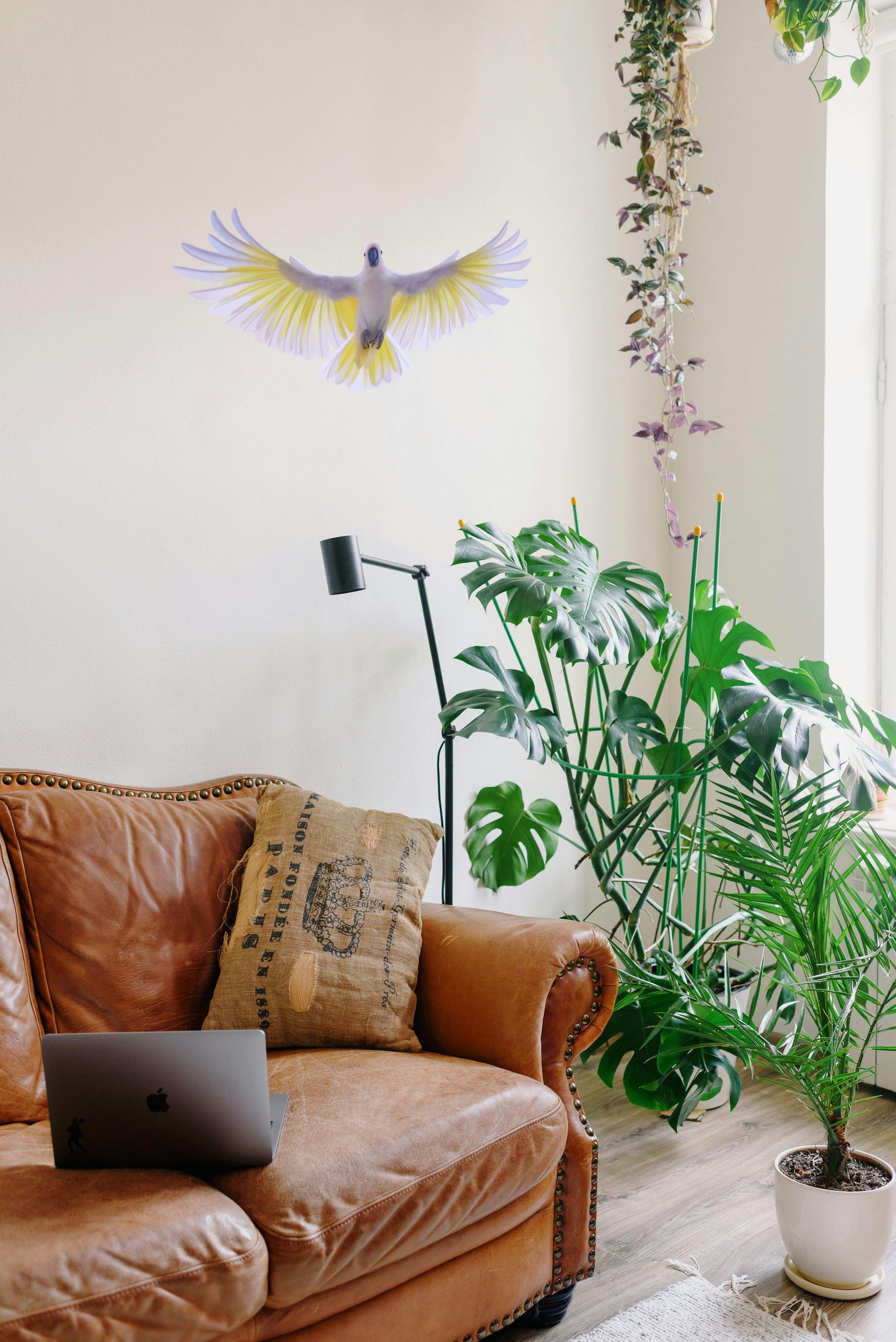 Large flying Cockatoo wall decal spanning 44cm, creating a dramatic nature-inspired statement piece in a modern living room.